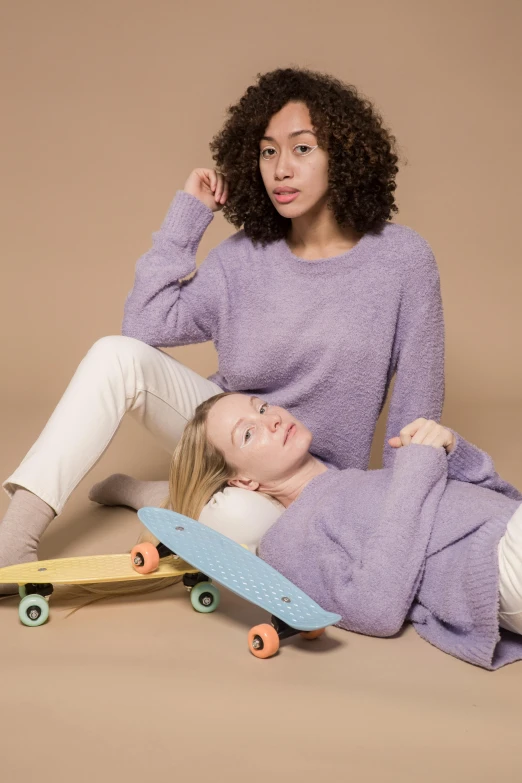 two women sitting next to each other on a skateboard, sweater, lavender, thumbnail, ready to model