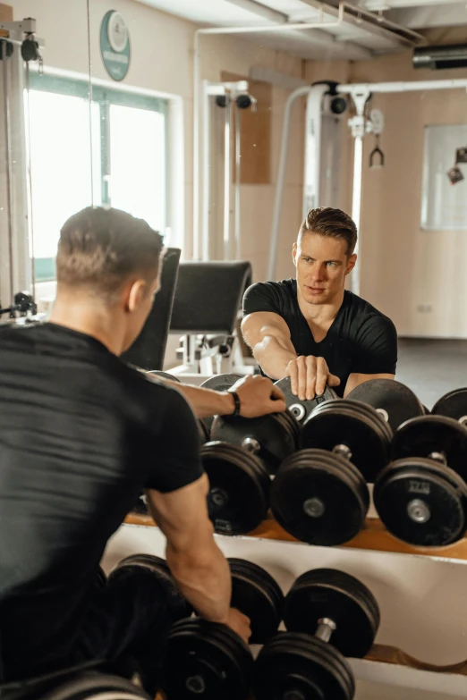 two men working out with dumbs in a gym, by Niko Henrichon, pexels contest winner, happening, lifting weights, lachlan bailey, inspect in inventory image, soft glow