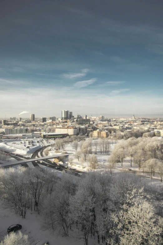 a view of a city from the top of a hill, by karlkka, happening, snowy environment, bright daylight, award-winning render, ultrawide lens”