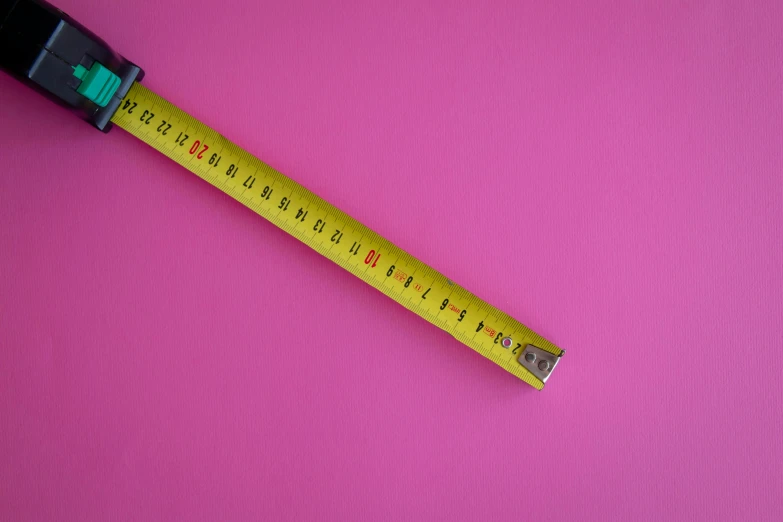 a measuring tape on a pink surface, by Meredith Dillman, pexels, visual art, 155 cm tall, single long stick, thick lining, bright colour