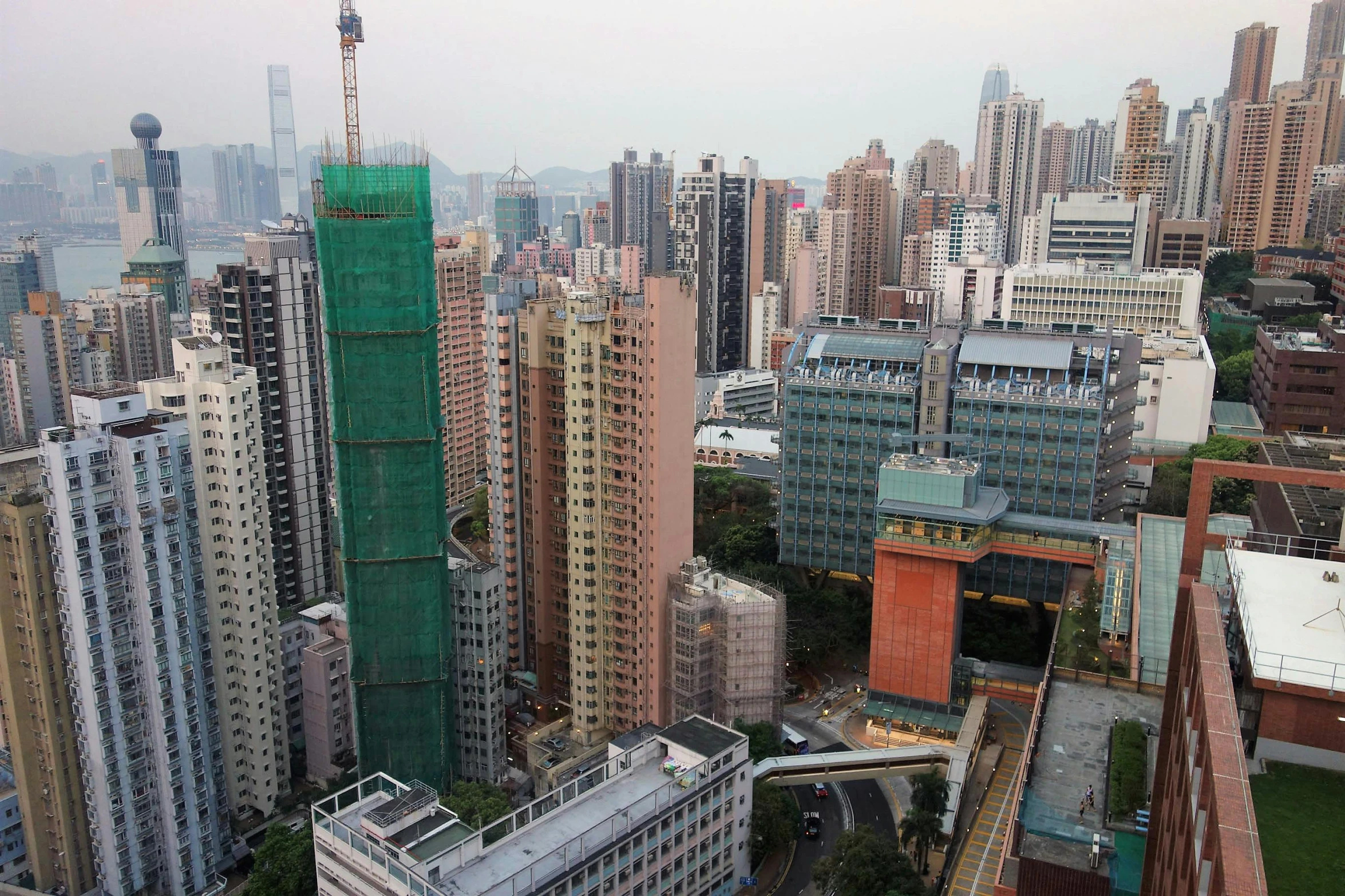 a view of a city from the top of a building, pexels contest winner, hyperrealism, hong kong buildings, poor quality, brightly colored buildings, three towers