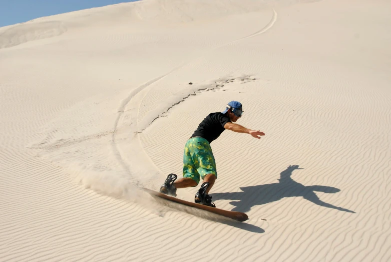 a man riding a snowboard down a snow covered slope, a picture, pexels contest winner, art nouveau, half submerged in heavy sand, australian desert, beaches, profile image