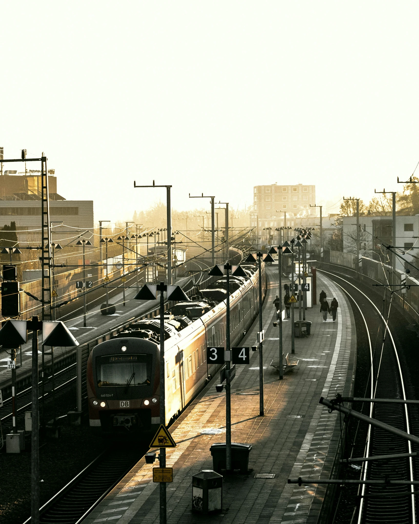 a large long train on a steel track, by Jan Tengnagel, pexels contest winner, city morning, french, lgbtq, 🚿🗝📝