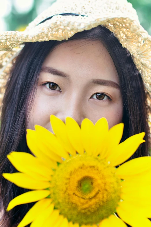 a woman in a straw hat holding a sunflower, inspired by Xie Sun, close - up photograph, bright gold eyes, pokimane, ao dai