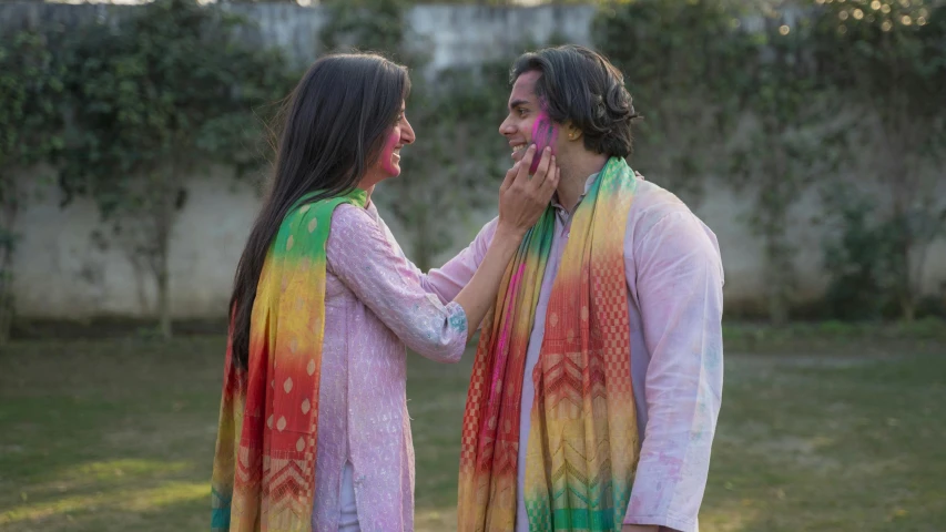 a man and a woman standing next to each other, pexels contest winner, color field, wearing a silk kurta, side profile artwork, fully covered in colorful paint, promotional image