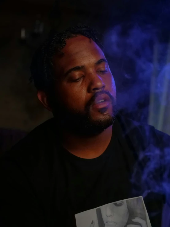 a man smoking a cigarette in a dark room, inspired by Paul Georges, trending on reddit, : kendrick lamar, ( ( theatrical ) ), profile image, thicc