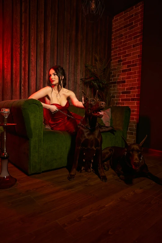 a woman sitting on a green couch next to a dog, an album cover, by Winona Nelson, pexels contest winner, conceptual art, portrait of megan fox as demon, gentleman's club lounge, red puppils, lawther sit at table playing dnd