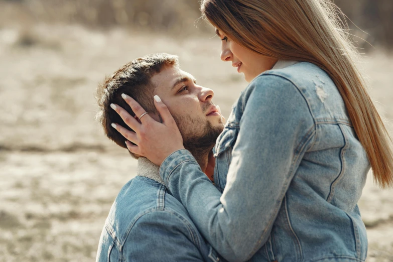 a man sitting next to a woman in a field, trending on pexels, romanticism, wearing a jeans jackets, touching heads, headshot, maxim sukharev