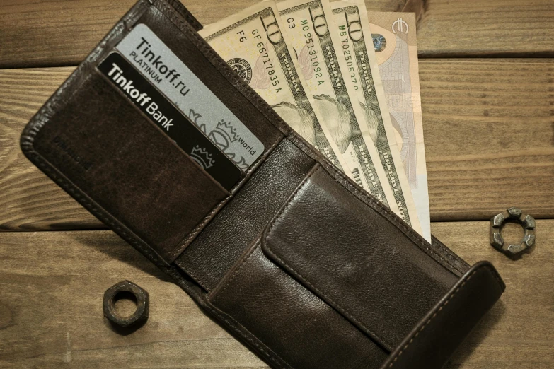a wallet with a credit card sticking out of it, by Niko Henrichon, pexels, photorealistic high detail, cash on a sidetable, brown, medium close - up