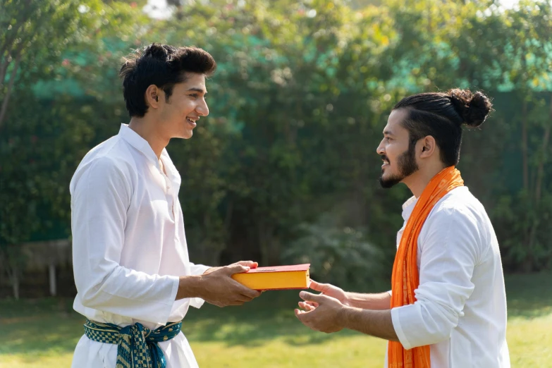 a couple of men standing next to each other, pexels contest winner, samikshavad, giving gifts to people, avatar image, religious, picnic