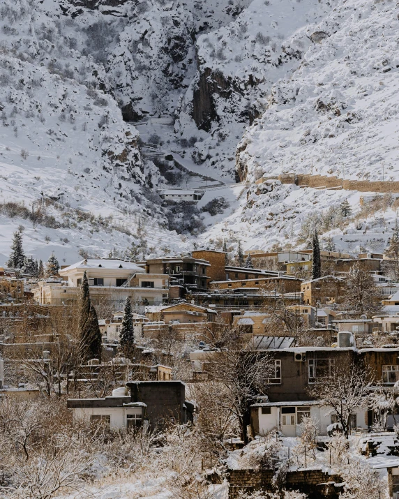 a village covered in snow with a mountain in the background, pexels contest winner, les nabis, kurdish lawyer, background image, located in hajibektash complex, a blond