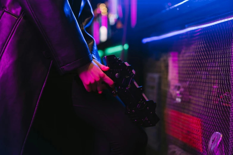 a close up of a person holding a camera, cyberpunk art, by Nick Fudge, unsplash, nightclub background, ground level shot, closed limbo room, bisexual lighting