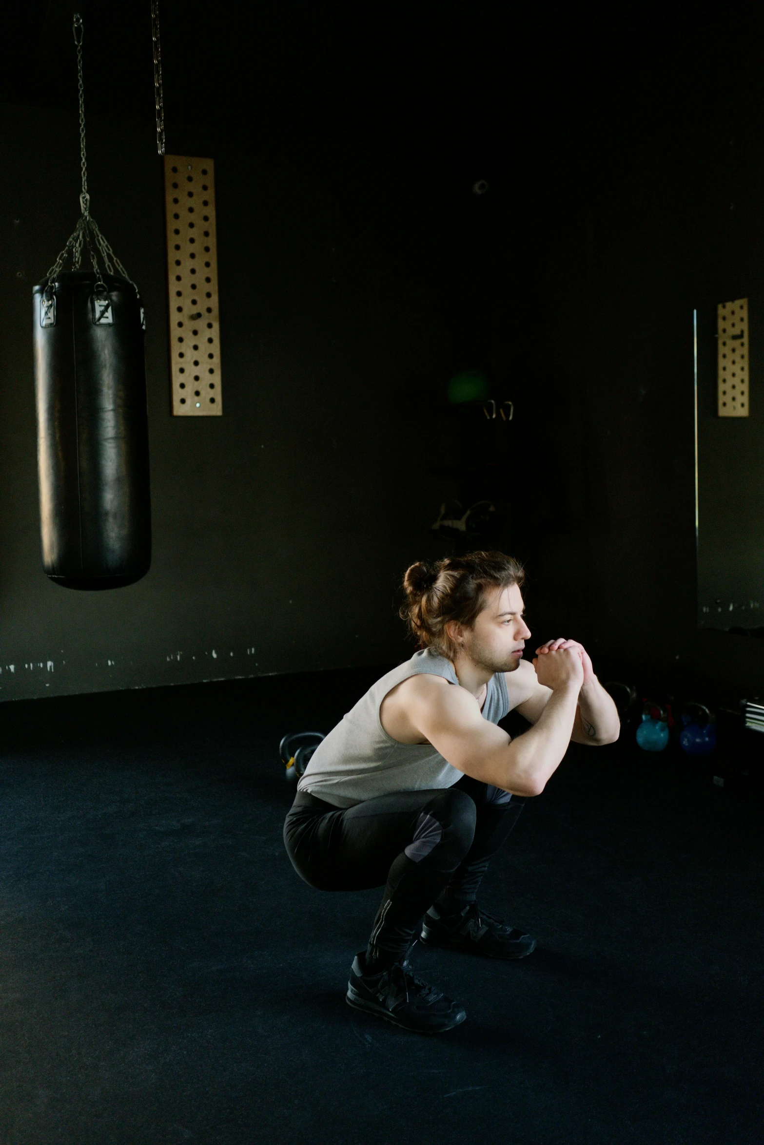 a woman squatting in front of a punching bag, by Sara Saftleven, pexels contest winner, renaissance, athletic man in his 30s, full growth from the back, gif, lachlan bailey