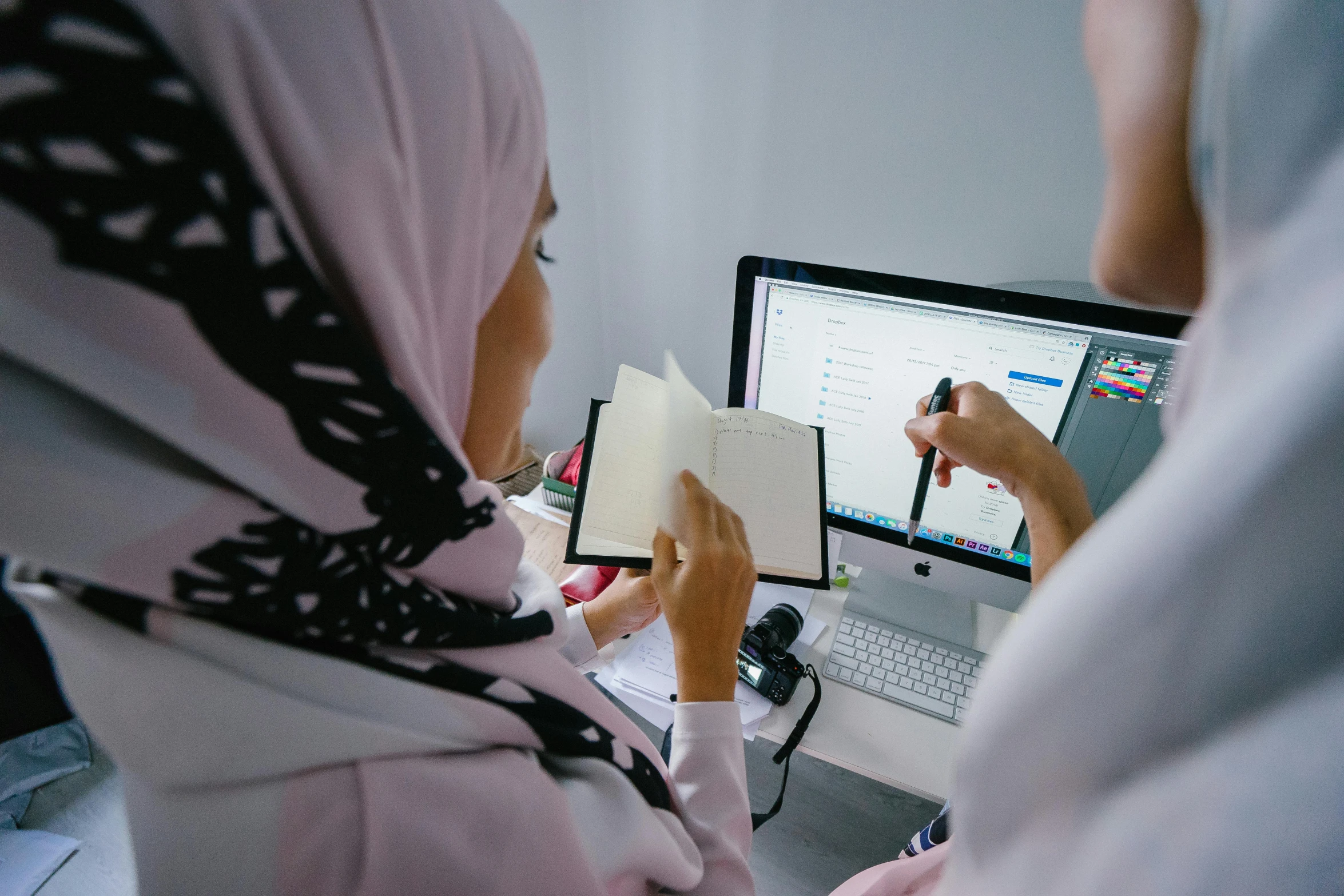 two women are looking at a computer screen, by Maryam Hashemi, pexels contest winner, hurufiyya, holding pencil, erak note, digital medical equipment, blank