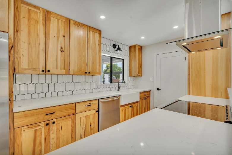 a kitchen with wooden cabinets and white counter tops, by Austin English, unsplash, moab, upscaled to 4 k, thumbnail, neotraditional modern