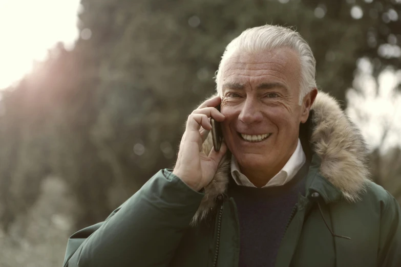 a man in a parka talking on a cell phone, inspired by Werner Andermatt, pexels contest winner, white haired, smiling male, 15081959 21121991 01012000 4k, #green