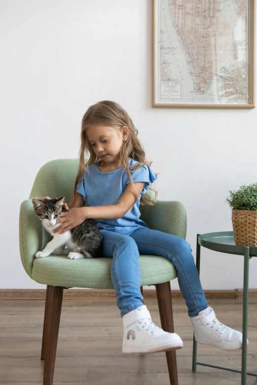 a little girl sitting in a chair with a cat, pexels contest winner, incoherents, demur, avocado armchair, white ( cat ) girl, medium height