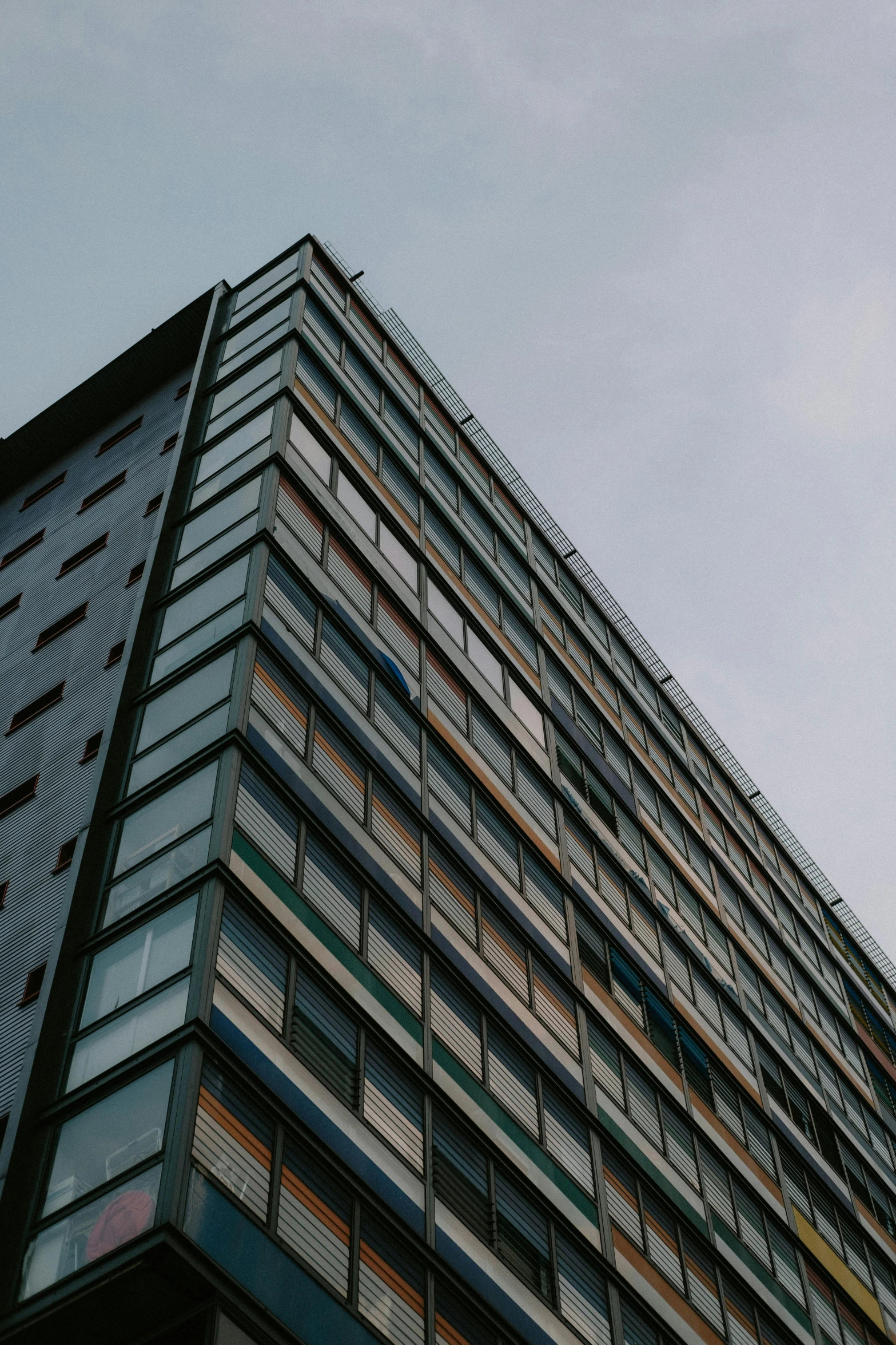 a tall building with lots of windows on top of it, unsplash, brutalism, glasgow, low quality photo, colour photograph, panels