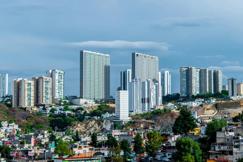 a view of a city from the top of a hill, by Alejandro Obregón, pexels contest winner, hyperrealism, three towers, slide show, high resolution photo, 1 5 9 5