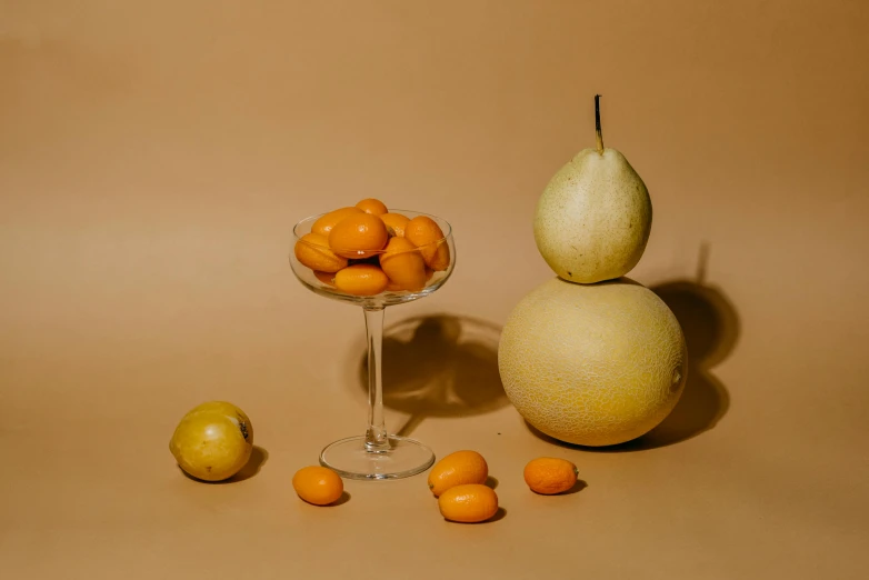 a glass bowl filled with oranges and a pear, a still life, unsplash contest winner, inflateble shapes, background image, mango, pale smooth