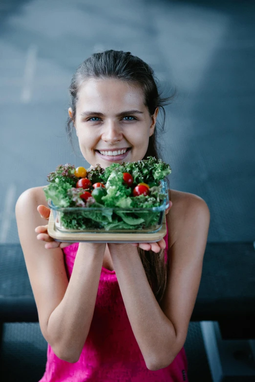 a woman holding a plate with a salad on it, pexels contest winner, photo of young woman, square, fit girl, headshot