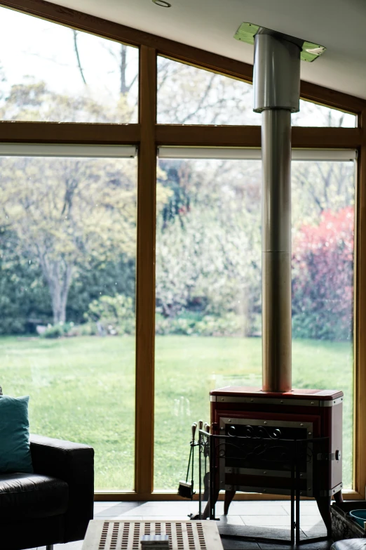 a living room filled with furniture and a fire place, a portrait, flickr, large green glass windows, garden environment, panorama shot, autumnal