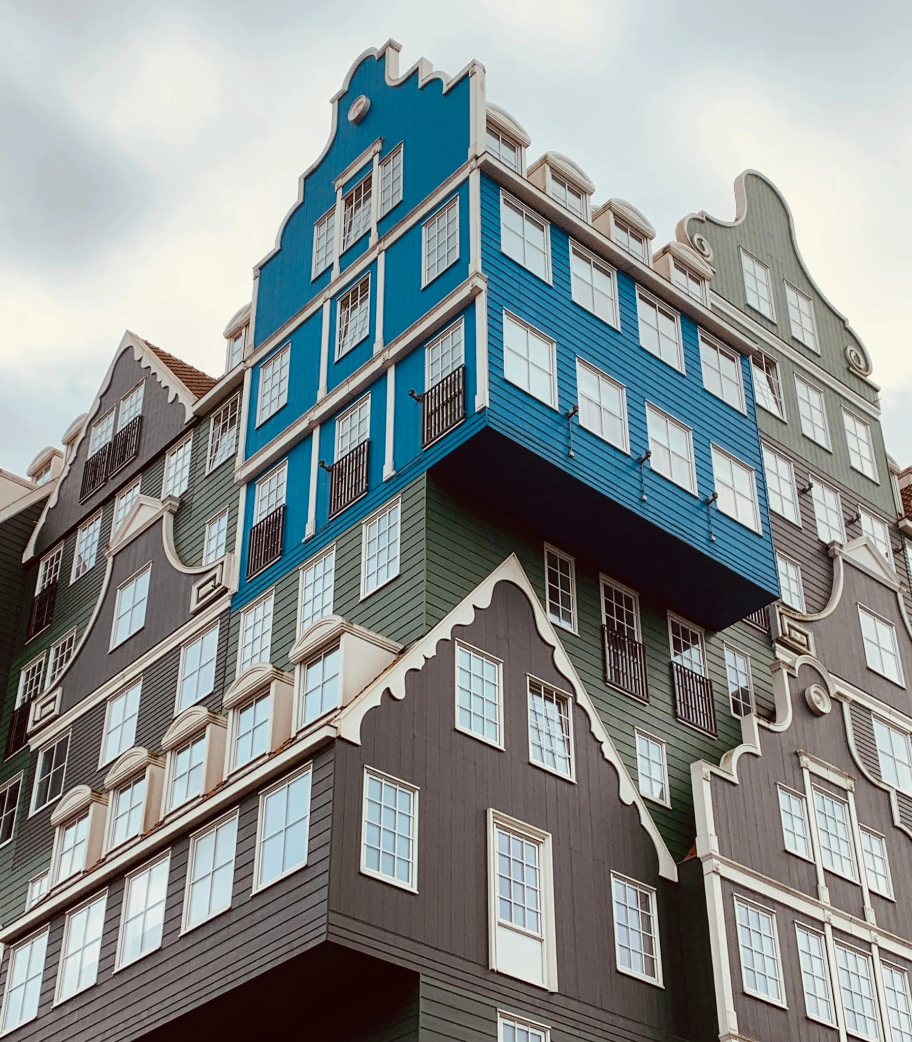 a tall building with lots of windows on top of it, pexels contest winner, de stijl, delftware, blue and gray colors, colorful warcraft architecture, a wooden