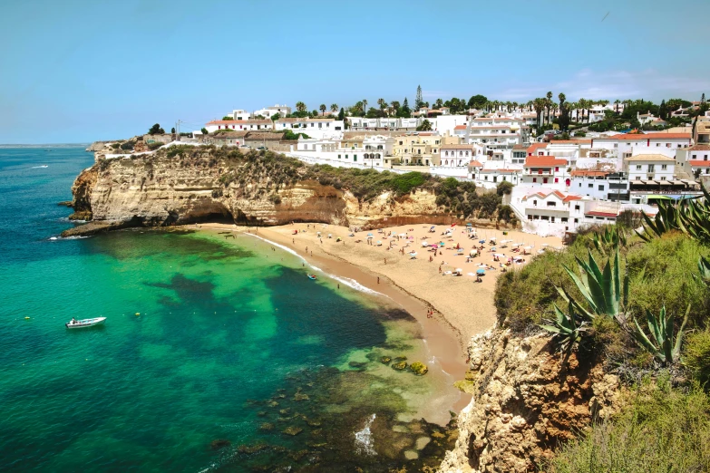 a group of people standing on top of a beach next to a body of water, renaissance, cliffside town, rocha, avatar image, travel guide