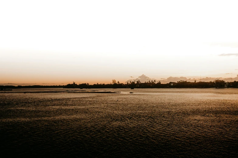 a man flying a kite on top of a sandy beach, unsplash, minimalism, sunset panorama, wide river and lake, inlets, golden hour photo