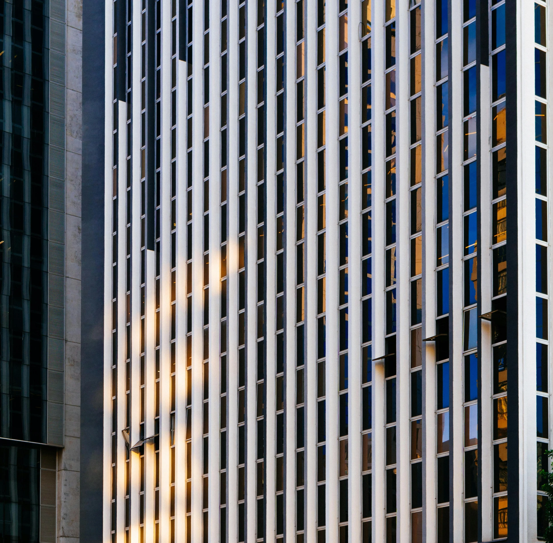 a very tall building with a lot of windows, by Jan Rustem, pexels contest winner, modernism, morning light showing injuries, square lines, chicago, white panels