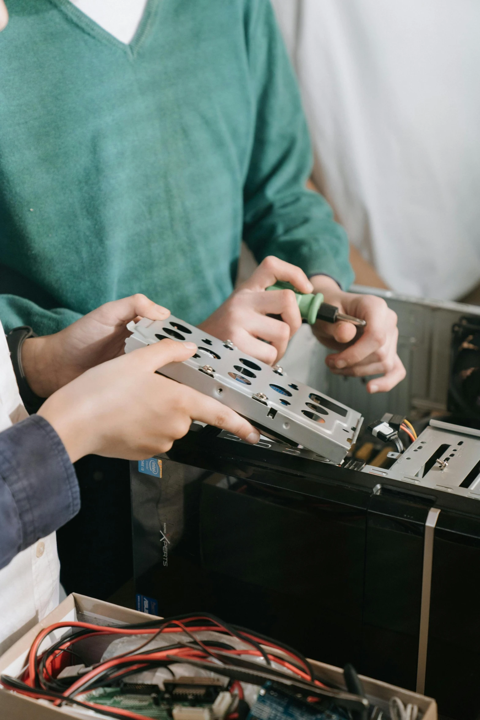 a couple of men standing next to each other, pexels contest winner, assemblage, disassemble the computer, steel plating, promo image, medium close up shot