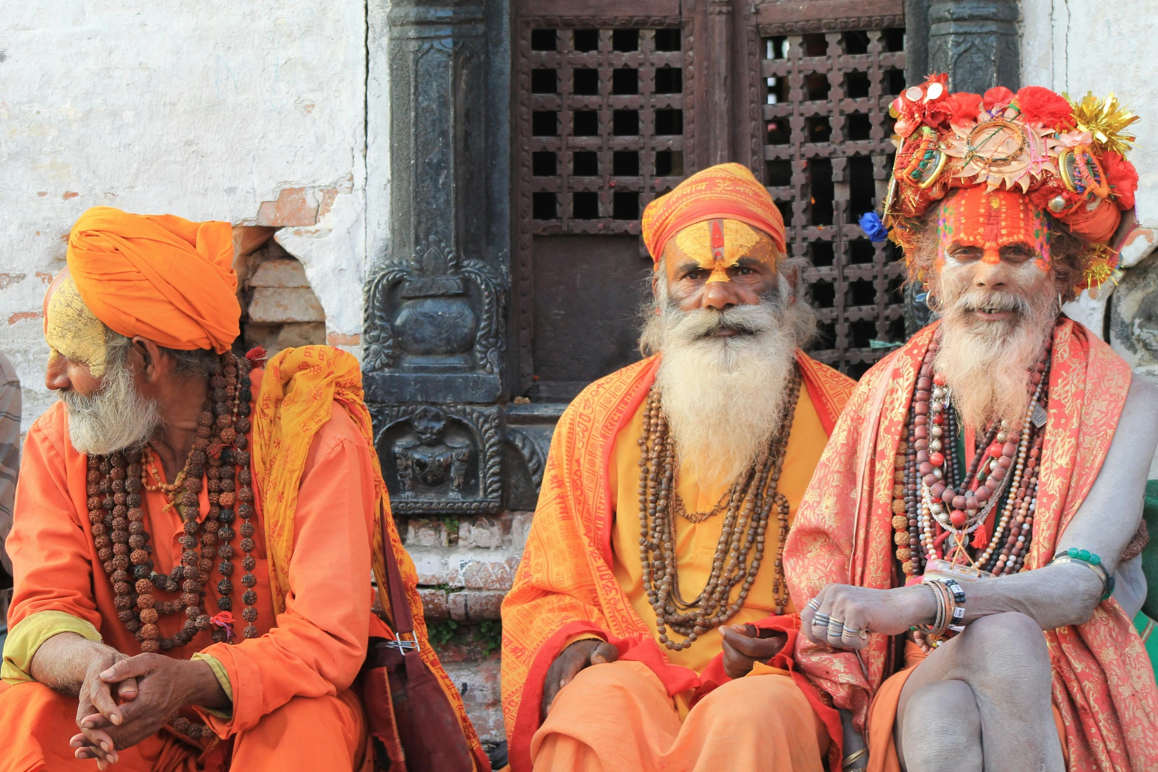 a group of men sitting next to each other, pexels contest winner, samikshavad, orange robe, avatar image, nepal, medium shot of two characters