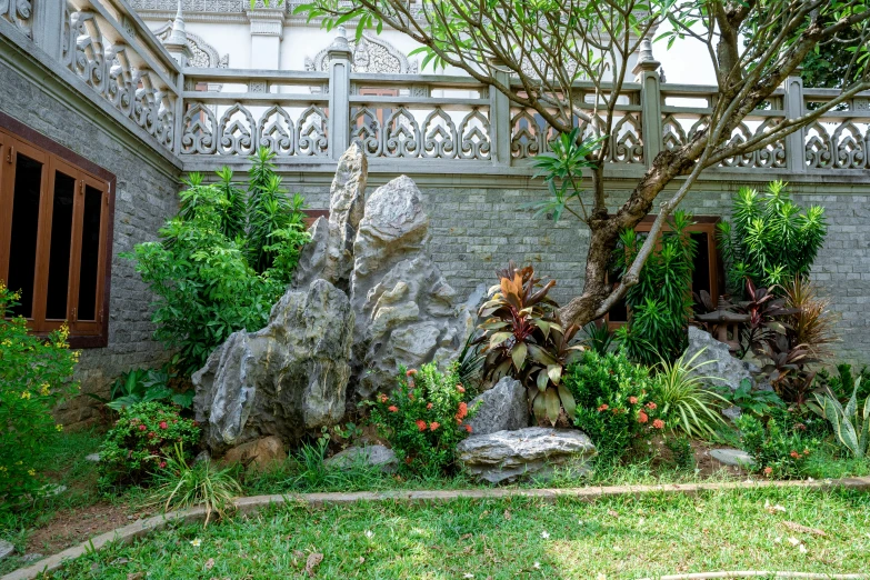 a large rock sitting in the middle of a lush green yard, a marble sculpture, art nouveau, in style of lam manh, green terrace, exterior photo, illustration »