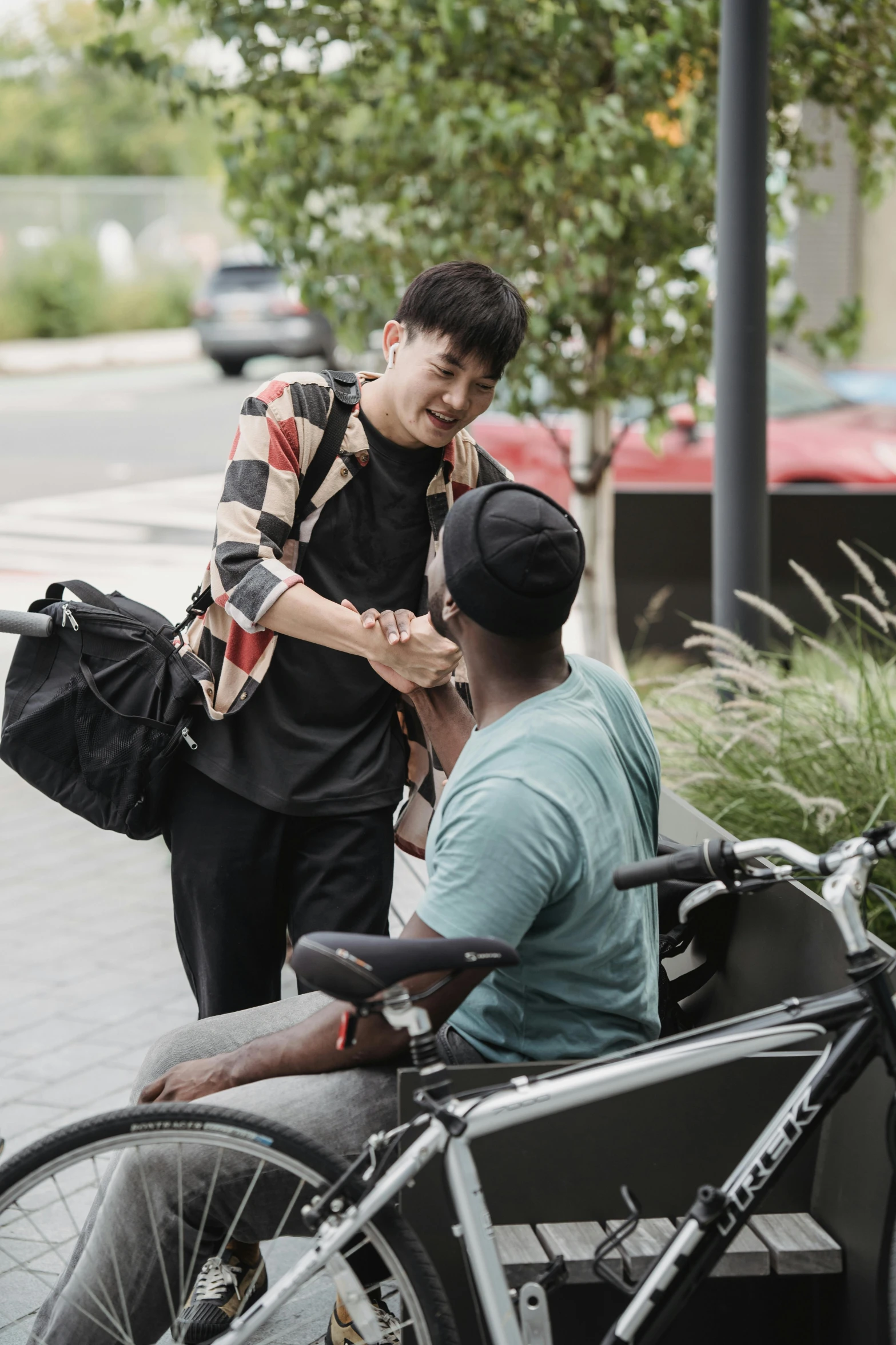 a man in a wheelchair talking to another man, by Jang Seung-eop, trending on unsplash, happening, woman holding another woman, square, moped, shaking hands