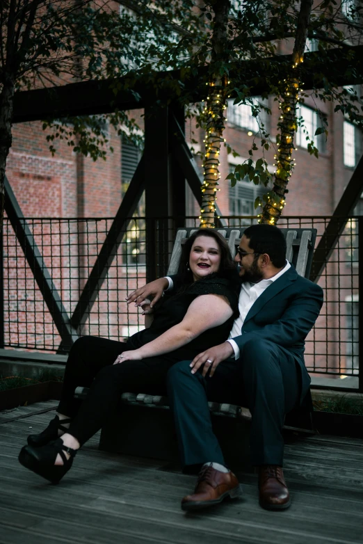 a man and a woman sitting on a bench, a portrait, by Kristin Nelson, pexels contest winner, alluring plus sized model, black, evening time, intertwined full body view
