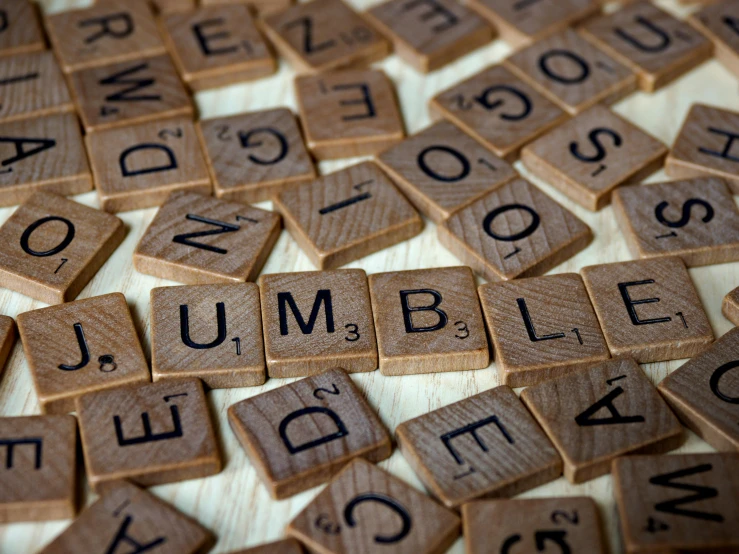 a pile of wooden scrabbles sitting on top of a table, by Daniel Lieske, pixabay, letterism, what a bumbler!, tumbleweed, closed limbo room, a close-up