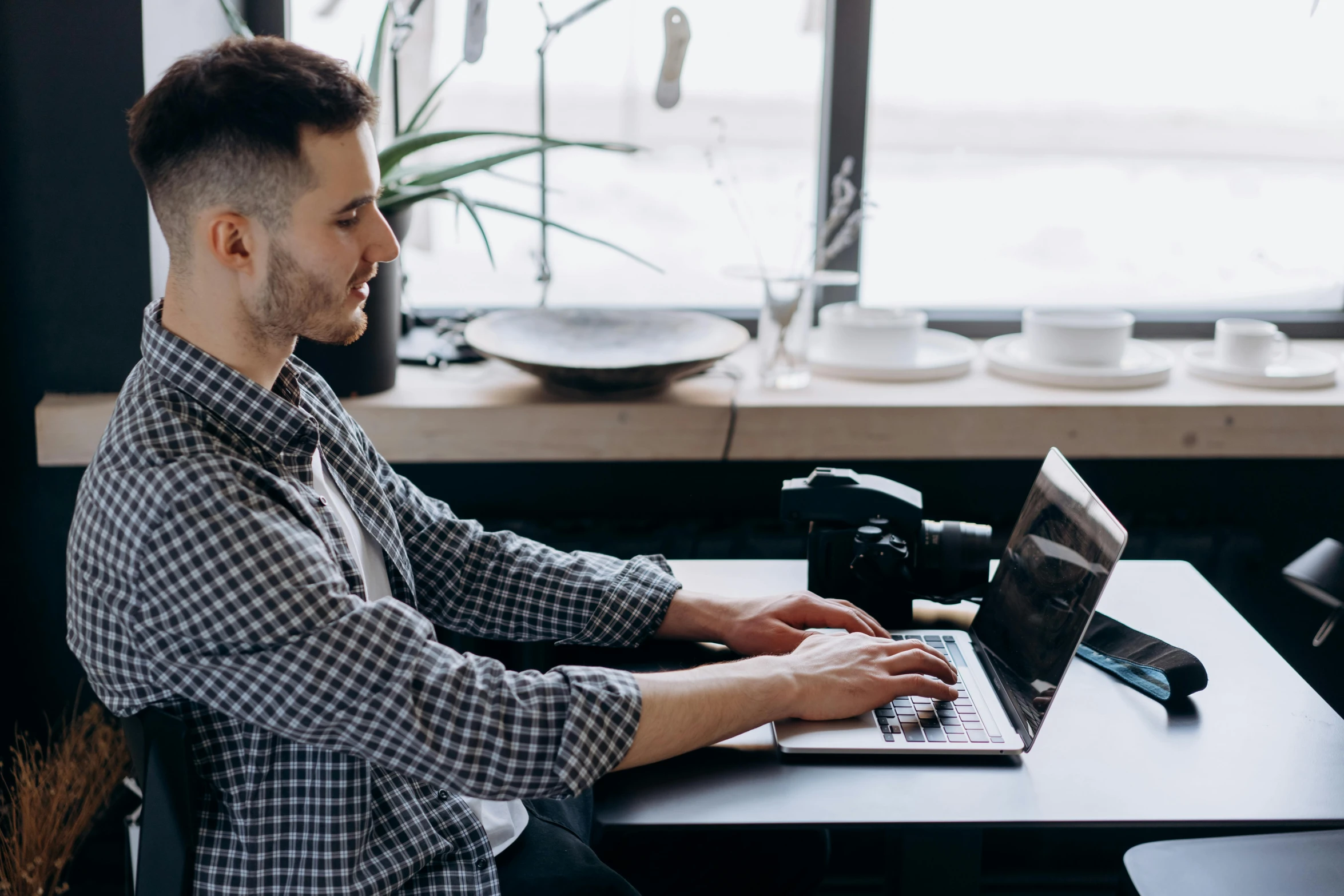 a man sitting at a table using a laptop computer, pexels contest winner, lachlan bailey, avatar image, wearing business casual dress, wētā fx