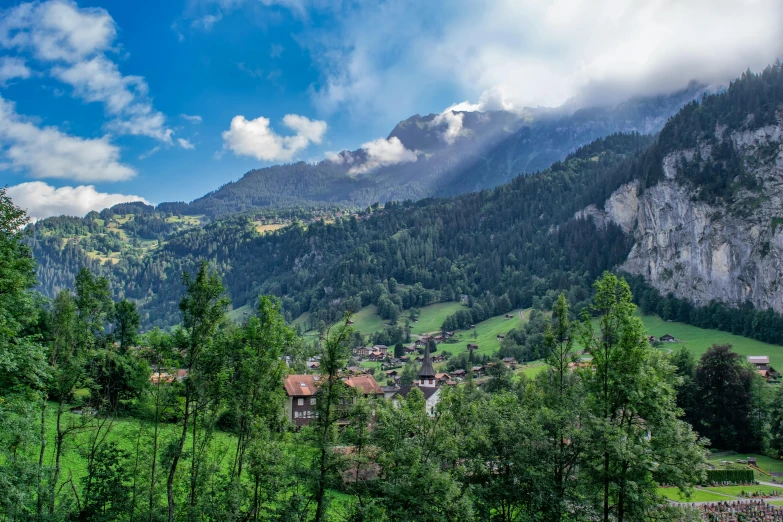 a scenic view of a village in the mountains, by Daren Bader, pexels contest winner, renaissance, lauterbrunnen valley, lush forests, avatar image