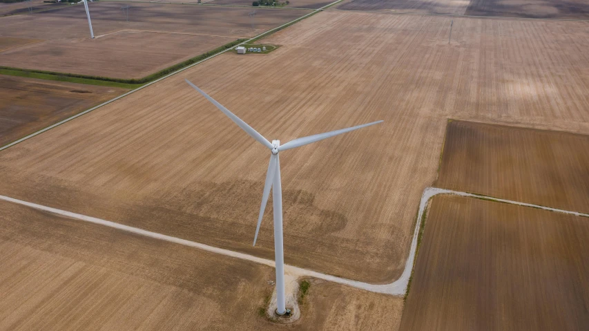 an aerial view of a wind turbine in a field, by Jacob Burck, pexels contest winner, from wheaton illinois, ultra high detailed, 15081959 21121991 01012000 4k, epic scale ultrawide angle