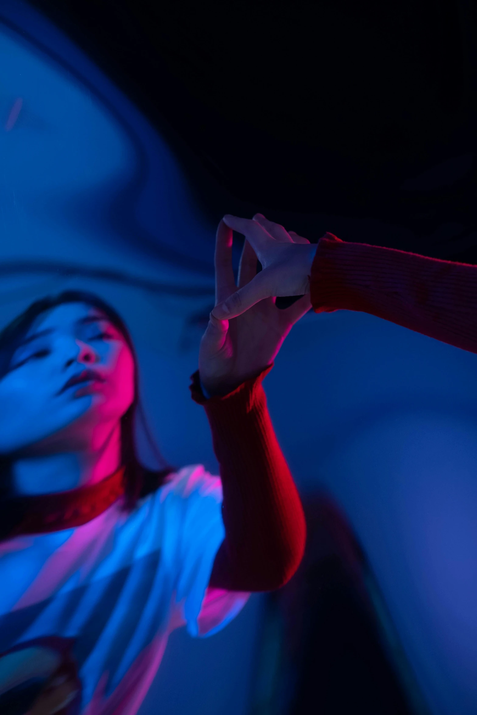 a man holding a tennis racquet on top of a tennis court, an album cover, trending on pexels, interactive art, blue and red lights, woman holding another woman, hands shielding face, at a rave