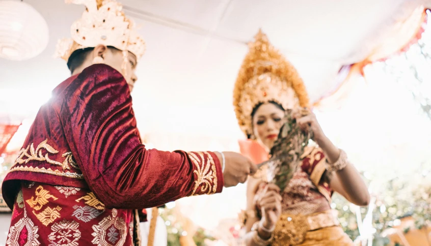 a man putting a crown on a woman's head, by Daniel Lieske, pexels contest winner, hurufiyya, ceremonial ritual, arsitektur nusantara, background image, thumbnail