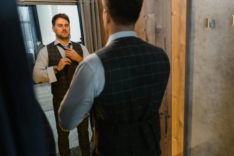 a man adjusting his tie in front of a mirror, inspired by Harrington Mann, pexels contest winner, renaissance, wearing a waistcoat, full body image, lachlan bailey, wearing a plug suit