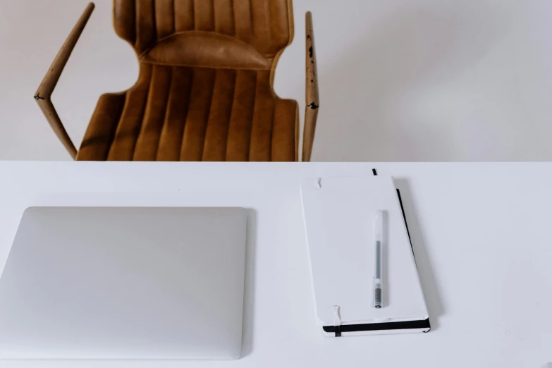 a laptop computer sitting on top of a white desk, inspired by Jan Müller, minimalism, notes, brown, overview, loundraw