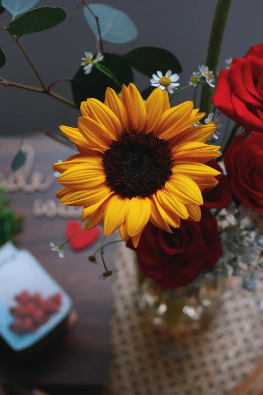 a vase filled with red roses and yellow sunflowers, pexels contest winner, detail shot, sweet, single, centerpiece