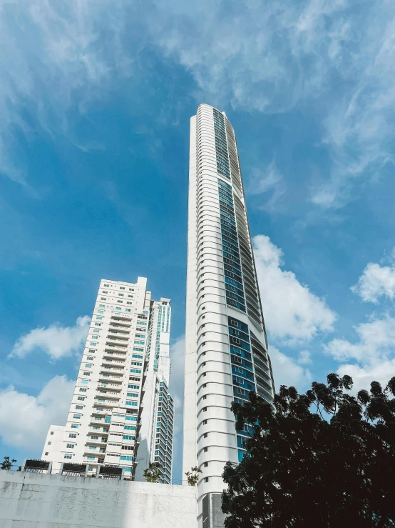 a couple of tall buildings sitting next to each other, by Robbie Trevino, pexels contest winner, modernism, gold coast australia, white marble buildings, profile image, singapore ( 2 0 1 8 )