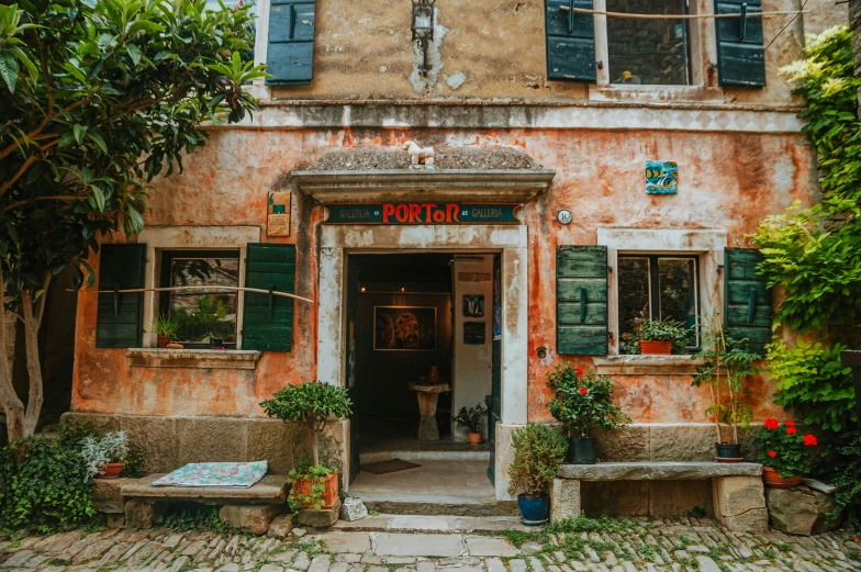 a building with a bench in front of it, pexels contest winner, folk art, olive garden, doorway, terracotta, thumbnail