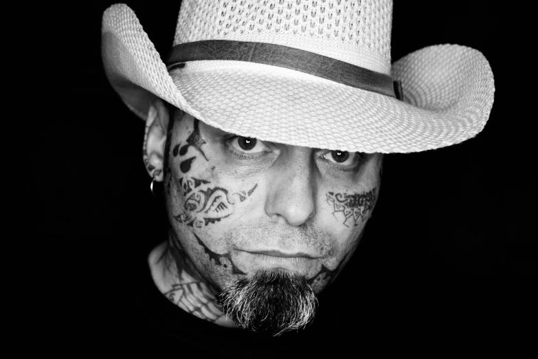 a man with tattoos on his face wearing a hat, a tattoo, inspired by Dave Arredondo, pixabay, lowbrow, portrait image, detailed white, headshot photo, masterpiece!!!
