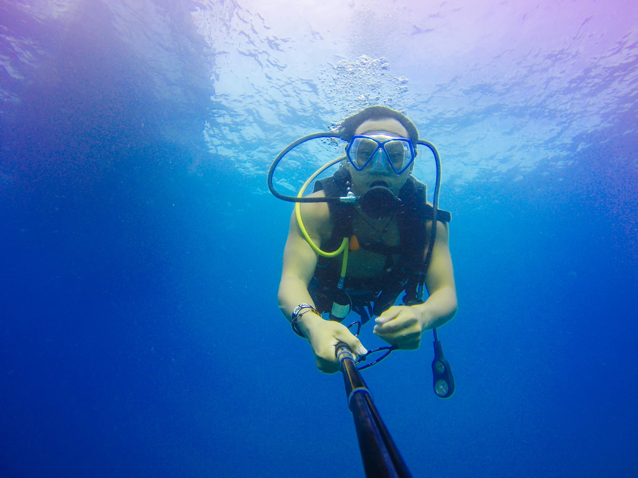 a person that is in the water with a scuba gear, pexels contest winner, deep blue, avatar image, underwater soft colours, fishing