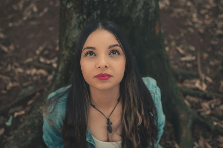 a beautiful young woman sitting in front of a tree, inspired by Elsa Bleda, pexels contest winner, thick lips, avatar image, beautiful mexican woman, low quality photo