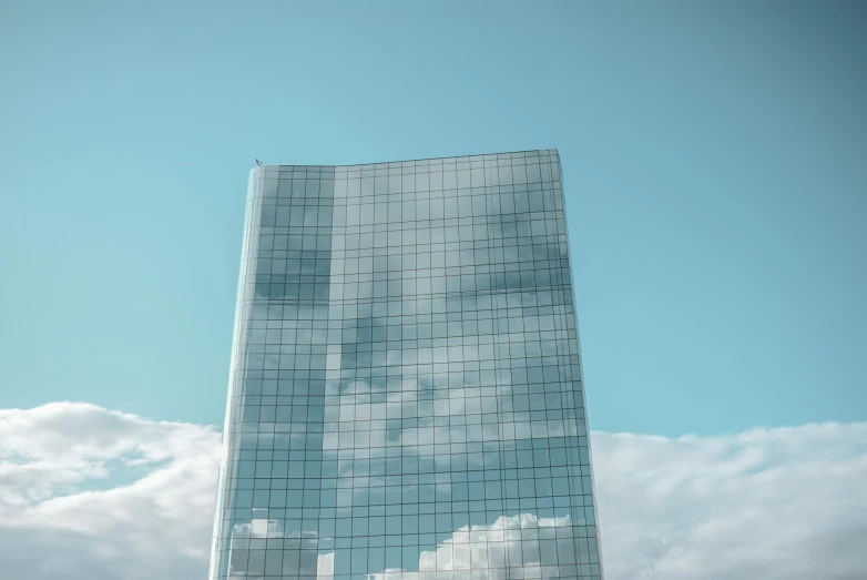 a very tall building with a lot of windows, inspired by Richard Wilson, pexels contest winner, cumulus, computer wallpaper, light blue sky, reflection